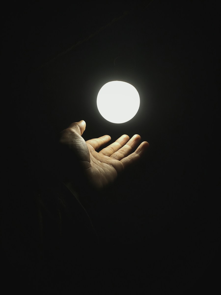 a hand holding a light in the dark