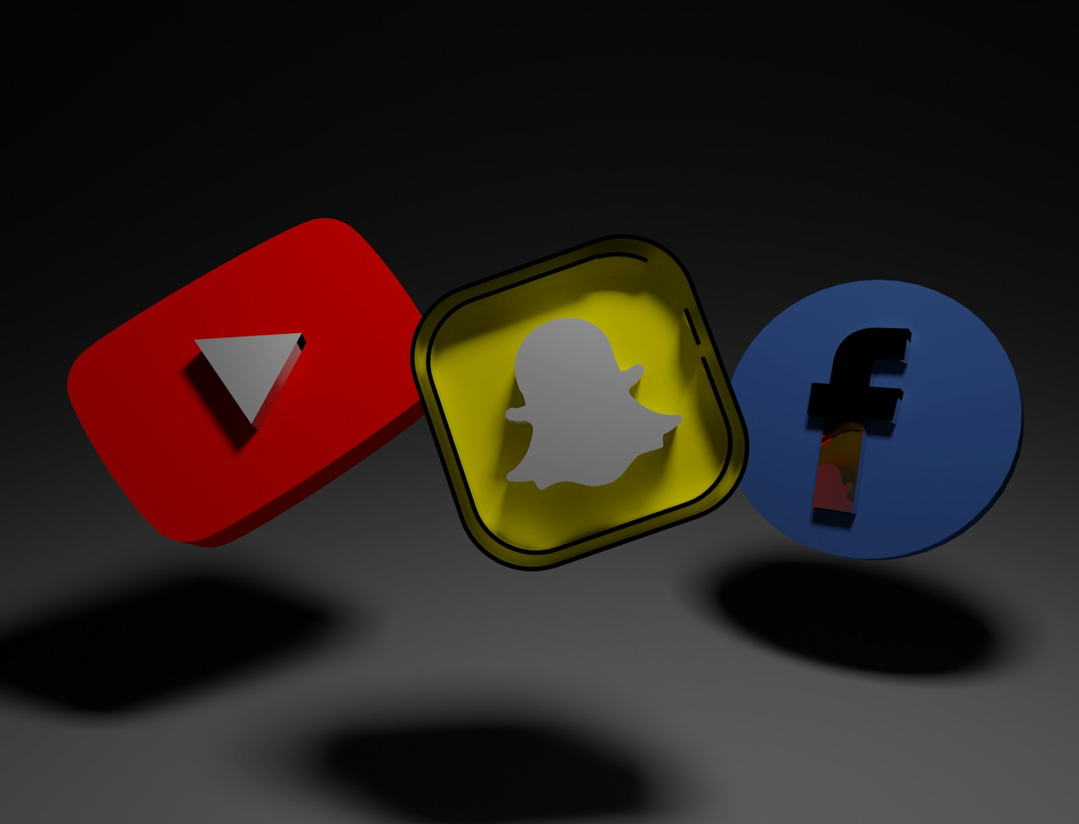 a group of three different colored objects on a black background