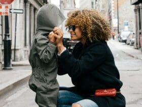 woman holding kid at the street